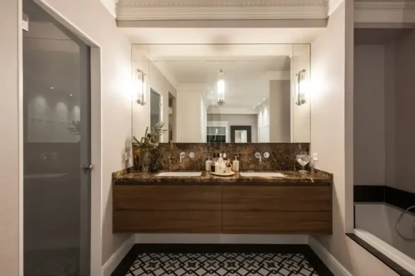 Tendencias interiorismo2026. Pared de baño con espejo y lavamanos